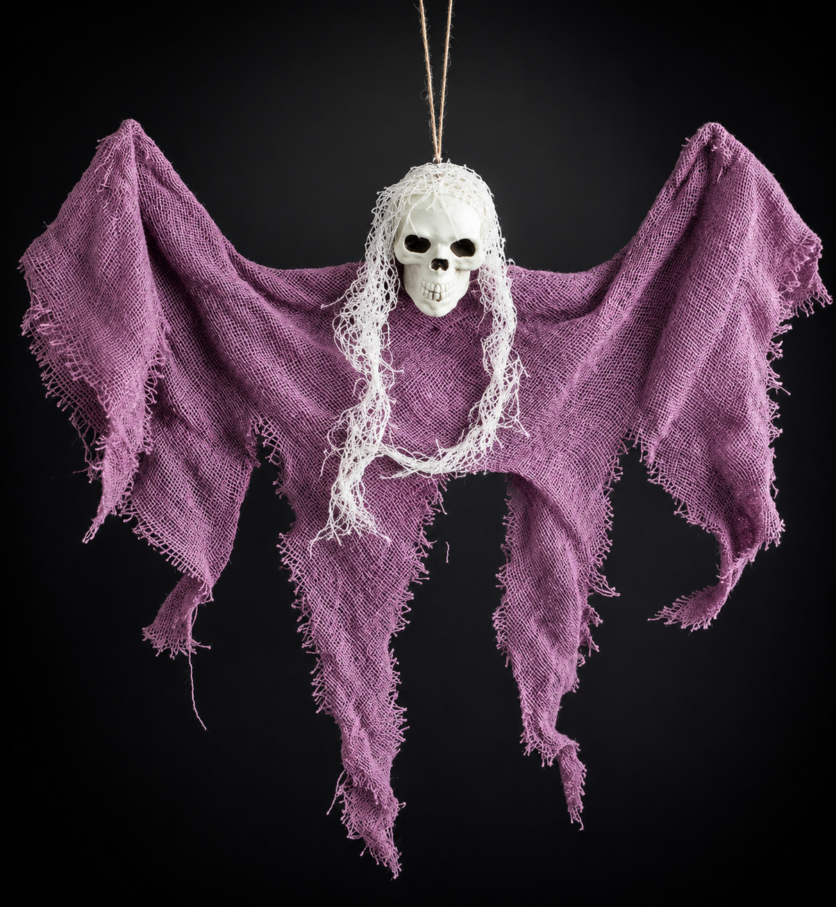 Halloween skull decoration hung outdoors as spooky yard decor